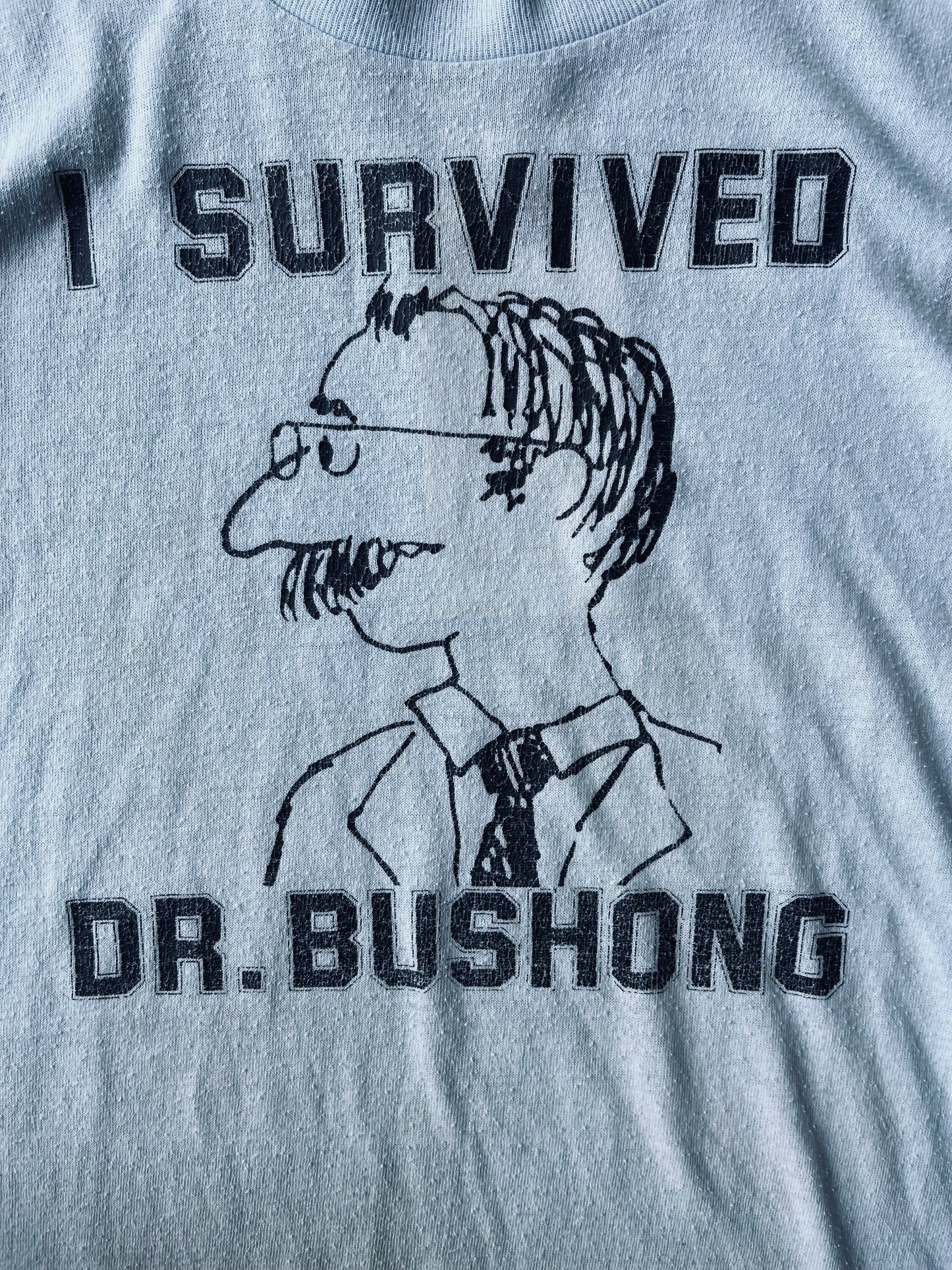 1980’s “I Survived Dr. Bushong” Graphic Tee | Large